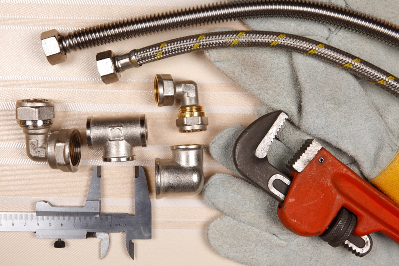 Plumber working on pipes in a South Kensington home